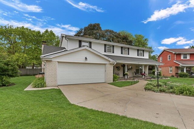 2310 Malik Ct, Glenview, IL 60025 - view of front facade with a porch, brick siding, a garage, and a chimney