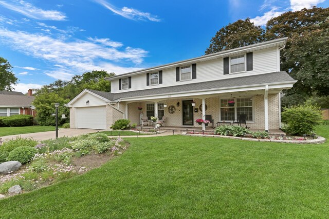 2310 Malik Ct, Glenview, IL 60025 - view of front facade with covered porch, concrete driveway, brick siding, a front yard, and a garage