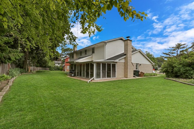 2310 Malik Ct, Glenview, IL 60025 - back of property featuring a sunroom, a chimney, brick siding, and a shingled roof