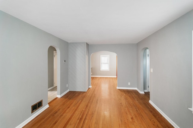 3256 186th St, Lansing, IL 60438 - empty room with arched walkways and light wood-type flooring