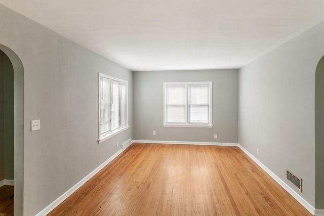 3256 186th St, Lansing, IL 60438 - empty room featuring arched walkways and light wood-style flooring