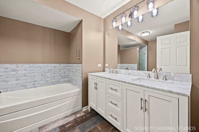 2312 Scott Ln Unit 2312, Aurora, IL 60502 - bathroom featuring double vanity, a bath, and wood finished floors