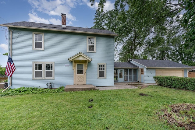 1018 Jericho Rd, Aurora, IL 60506 - rear view of house with a chimney, a yard, a sunroom, and a garage