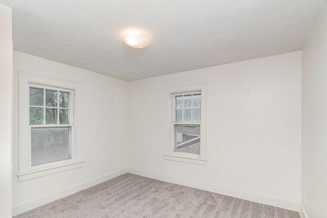 1018 Jericho Rd, Aurora, IL 60506 - unfurnished room featuring plenty of natural light, light carpet, and baseboards