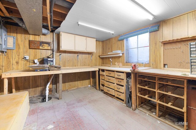 380 Ventura Club Dr, Roselle, IL 60172 - basement featuring a workshop area, wood walls, and electric panel