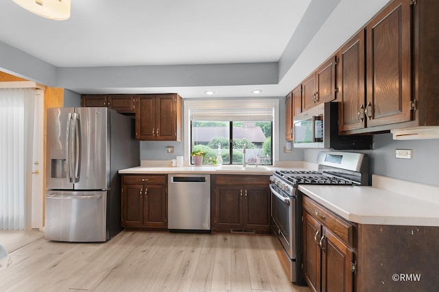380 Ventura Club Dr, Roselle, IL 60172 - kitchen featuring stainless steel appliances, light wood-type flooring, light countertops, recessed lighting, and dark brown cabinetry