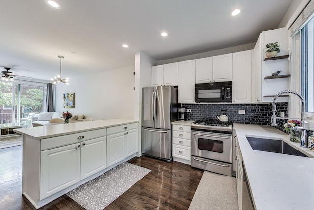 2801 N Wolcott Ave Unit L, Chicago, IL 60657 - kitchen with stainless steel appliances, a sink, a peninsula, open shelves, and light countertops