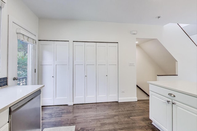 2801 N Wolcott Ave Unit L, Chicago, IL 60657 - kitchen featuring stainless steel dishwasher, light countertops, white cabinets, and dark wood-style flooring
