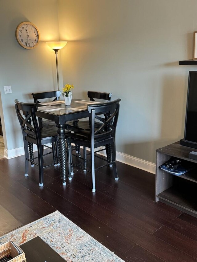 5555 N Cumberland Ave Unit 407, Chicago, IL 60656 - dining area featuring baseboards and dark wood-style flooring