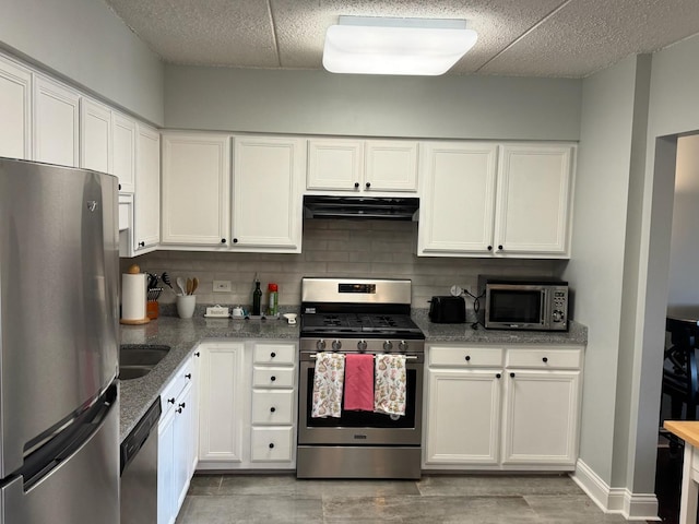 5555 N Cumberland Ave Unit 407, Chicago, IL 60656 - kitchen with appliances with stainless steel finishes, range hood, backsplash, white cabinets, and stone counters