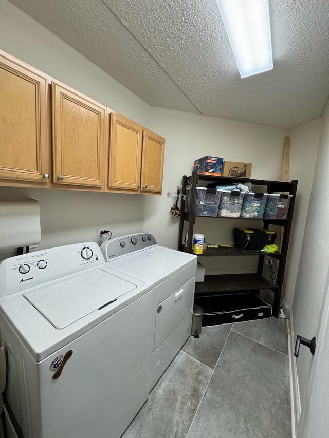 5555 N Cumberland Ave Unit 407, Chicago, IL 60656 - washroom with washer and dryer, cabinet space, and a textured ceiling
