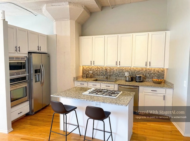 1530 S State St Unit 525, Chicago, IL 60605 - kitchen with appliances with stainless steel finishes, a sink, tasteful backsplash, light wood-type flooring, and lofted ceiling