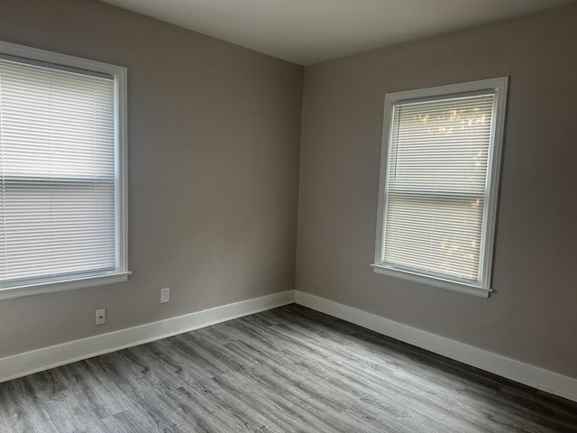 490 Country Club Dr, Kankakee, IL 60901 - unfurnished room with wood finished floors, baseboards, and healthy amount of natural light