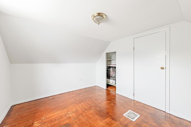 4640 S Winchester Ave, Chicago, IL 60609 - additional living space with vaulted ceiling, wood finished floors, and baseboards