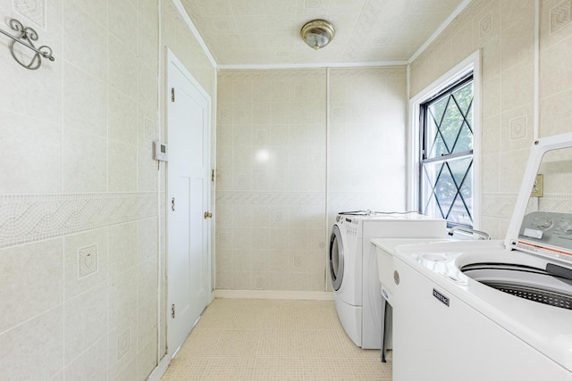 4640 S Winchester Ave, Chicago, IL 60609 - laundry room featuring tile walls, light tile patterned floors, washer and dryer, and crown molding