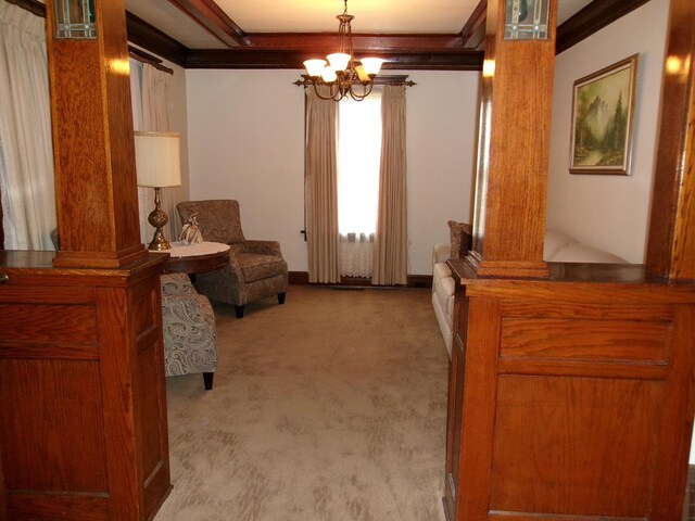 1425 Peoria St, Peru, IL 61354 - living area featuring decorative columns, a chandelier, carpet floors, and baseboards