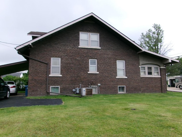 1425 Peoria St, Peru, IL 61354 - view of side of property with a yard, brick siding, and central AC unit