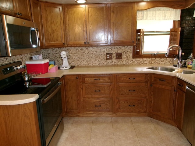 1425 Peoria St, Peru, IL 61354 - kitchen featuring stainless steel appliances, a sink, brown cabinets, and decorative backsplash