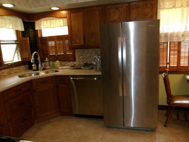 1425 Peoria St, Peru, IL 61354 - kitchen featuring appliances with stainless steel finishes, a sink, brown cabinets, light countertops, and light tile patterned floors