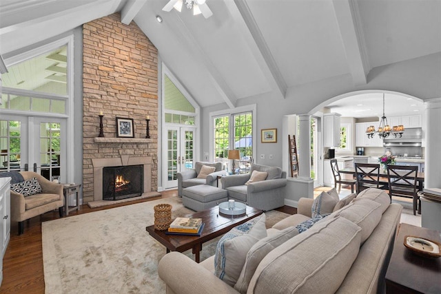 1135 Lawrence Ave, Lake Forest, IL 60045 - living area with arched walkways, french doors, dark wood-style floors, decorative columns, and beamed ceiling