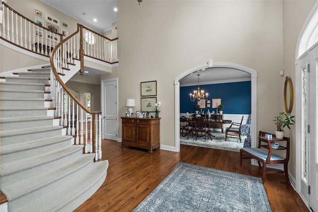 1135 Lawrence Ave, Lake Forest, IL 60045 - foyer featuring a high ceiling, arched walkways, wood finished floors, stairway, and a chandelier