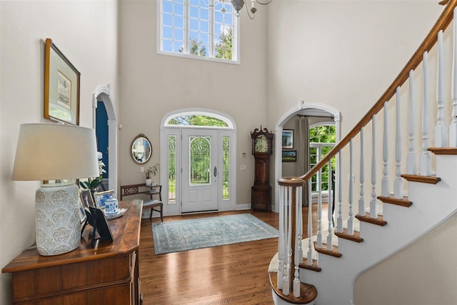 1135 Lawrence Ave, Lake Forest, IL 60045 - entryway with arched walkways, a high ceiling, wood finished floors, stairway, and a chandelier