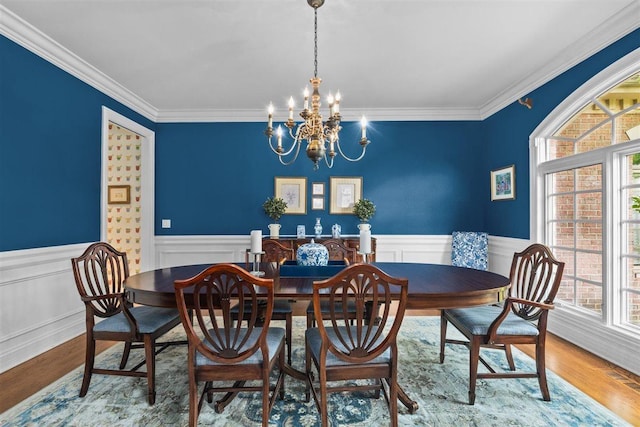 1135 Lawrence Ave, Lake Forest, IL 60045 - dining space featuring a chandelier, a wainscoted wall, crown molding, and wood finished floors