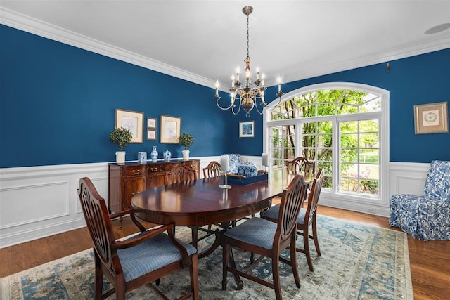 1135 Lawrence Ave, Lake Forest, IL 60045 - dining space featuring crown molding, a wainscoted wall, a chandelier, wood finished floors, and a decorative wall