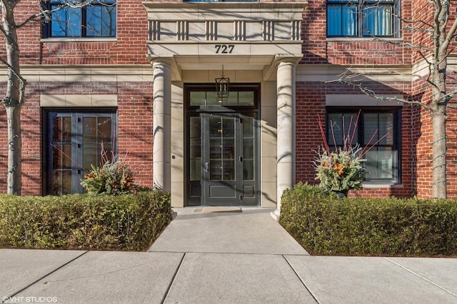 727 N Mckinley Rd Unit 100, Lake Forest, IL 60045 - property entrance with a balcony and brick siding
