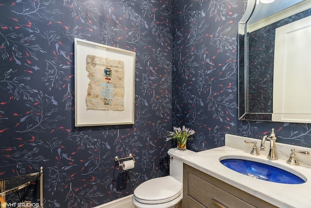 727 N Mckinley Rd Unit 100, Lake Forest, IL 60045 - bathroom featuring vanity, toilet, and wallpapered walls
