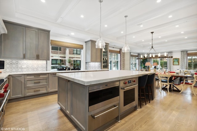 727 N Mckinley Rd Unit 100, Lake Forest, IL 60045 - kitchen featuring gray cabinetry, a warming drawer, light wood-style flooring, a center island, and recessed lighting