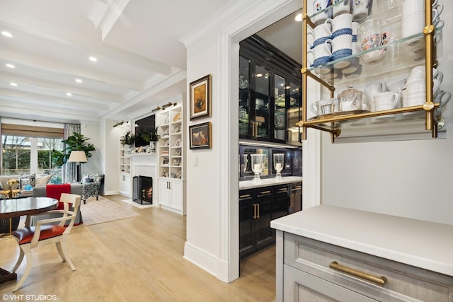 727 N Mckinley Rd Unit 100, Lake Forest, IL 60045 - bar with beamed ceiling, light wood finished floors, a fireplace with flush hearth, recessed lighting, and built in shelves