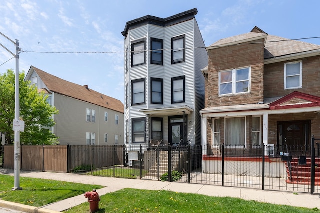 1630 N Avers Ave, Chicago, IL 60647 - view of property featuring a fenced front yard, stone siding, a gate, and a porch