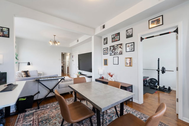 1630 N Avers Ave, Chicago, IL 60647 - dining room featuring wood finished floors, a chandelier, and baseboards