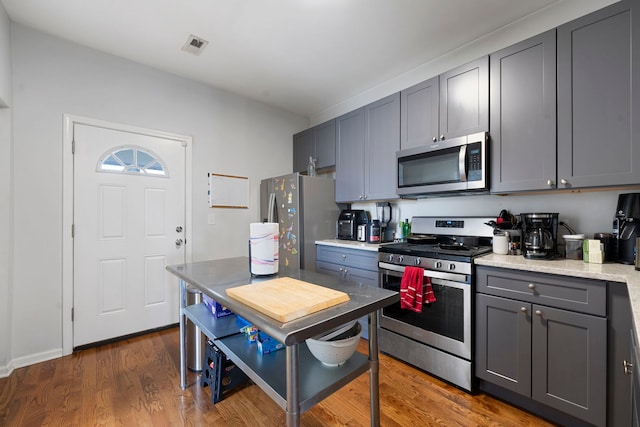 1630 N Avers Ave, Chicago, IL 60647 - kitchen featuring stainless steel appliances, gray cabinets, and wood finished floors