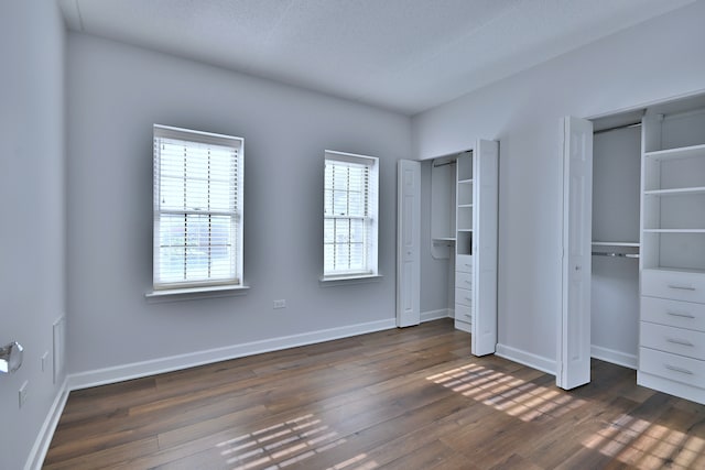 210 N Addison Ave Unit 201, Elmhurst, IL 60126 - unfurnished bedroom with multiple closets, multiple windows, and dark wood-style floors