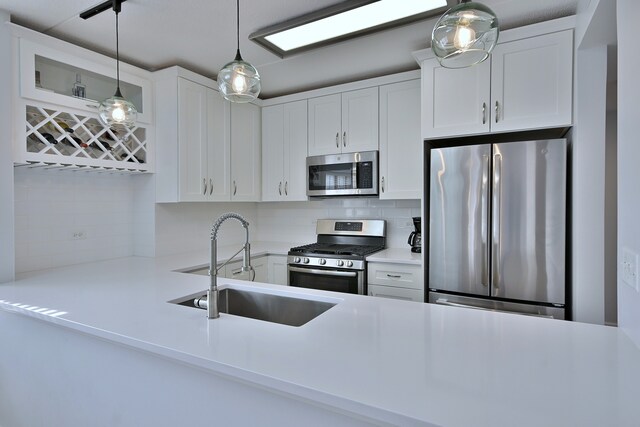 210 N Addison Ave Unit 201, Elmhurst, IL 60126 - kitchen featuring stainless steel appliances, a sink, decorative backsplash, and white cabinetry