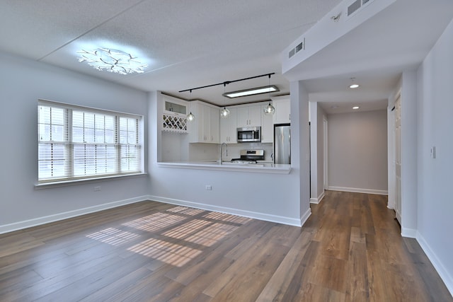 210 N Addison Ave Unit 201, Elmhurst, IL 60126 - kitchen with appliances with stainless steel finishes, a sink, light countertops, white cabinetry, and dark wood finished floors
