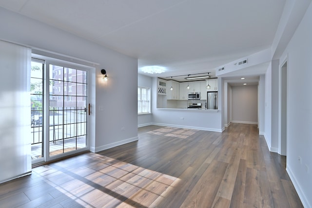 210 N Addison Ave Unit 201, Elmhurst, IL 60126 - unfurnished living room featuring dark wood-style floors and baseboards