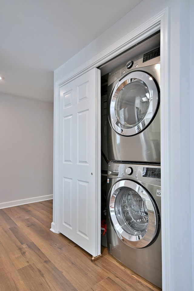 210 N Addison Ave Unit 201, Elmhurst, IL 60126 - laundry room featuring stacked washer and clothes dryer, wood finished floors, and baseboards