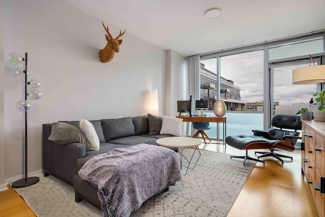 123 S Green St Unit 710B, Chicago, IL 60607 - living room featuring wood finished floors, a desk, and baseboards