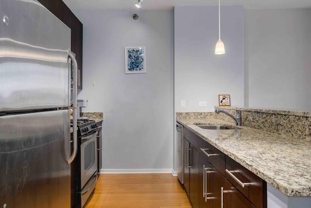 123 S Green St Unit 710B, Chicago, IL 60607 - kitchen with appliances with stainless steel finishes, a sink, light wood-type flooring, light stone counters, and baseboards