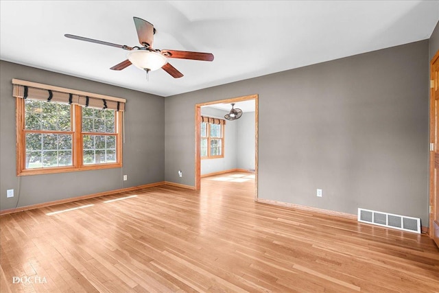 510 W Grant St, Sheridan, IL 60551 - empty room featuring healthy amount of natural light, light wood-type flooring, a ceiling fan, and a chandelier