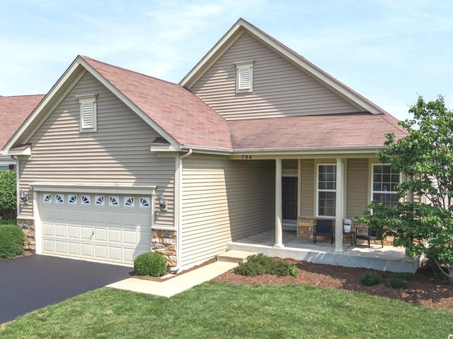 794 Suffield Ct, Oswego, IL 60543 - view of front facade featuring a porch, asphalt driveway, stone siding, roof with shingles, and an attached garage