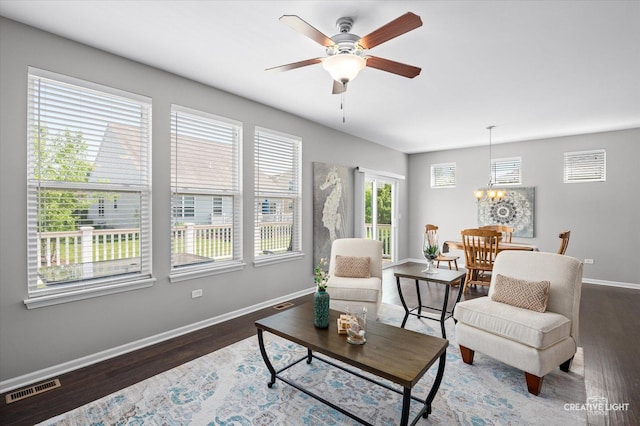 794 Suffield Ct, Oswego, IL 60543 - living room featuring wood finished floors, a chandelier, and a ceiling fan