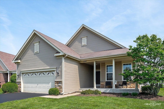 794 Suffield Ct, Oswego, IL 60543 - view of front facade with covered porch, stone siding, asphalt driveway, and a front yard