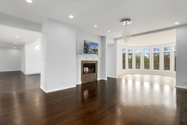 309 Dundee Rd, Barrington, IL 60010 - unfurnished living room with a premium fireplace, wood finished floors, baseboards, and recessed lighting