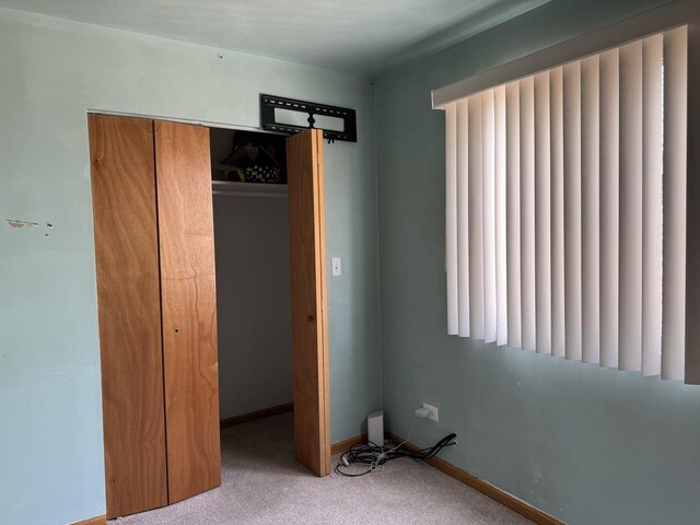 2628 N Mulligan Ave, Chicago, IL 60639 - unfurnished bedroom with carpet flooring, a closet, and baseboards