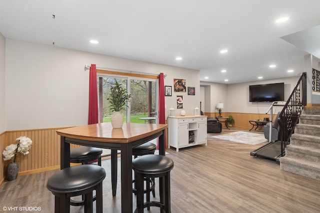 4515 Elmleaf Dr, Mchenry, IL 60051 - dining room featuring a wainscoted wall, stairway, light wood-style floors, wood walls, and recessed lighting