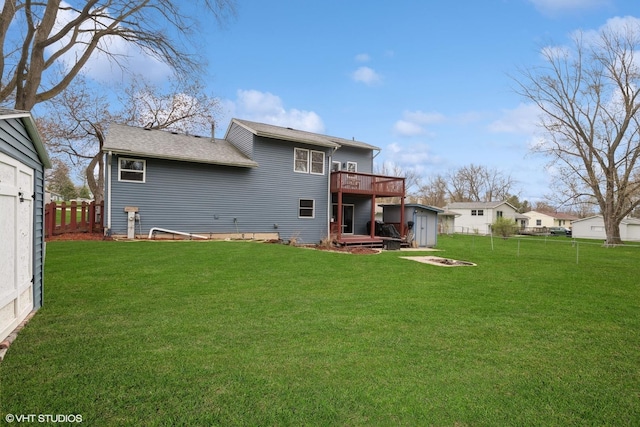 4515 Elmleaf Dr, Mchenry, IL 60051 - rear view of house with a wooden deck, a storage unit, a fenced backyard, an outdoor fire pit, and roof with shingles